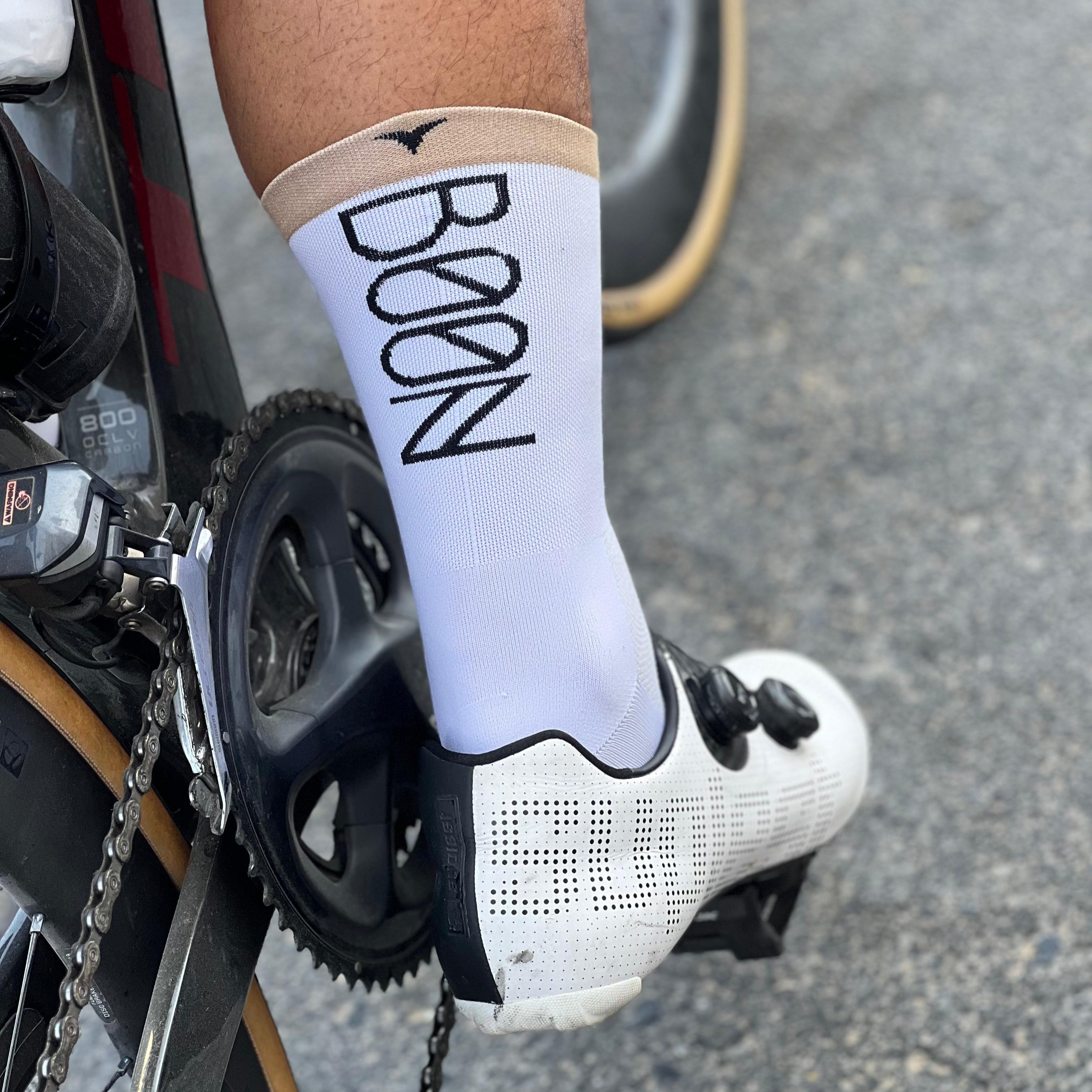 Cyclist showing off custom cycling socks with BOON design