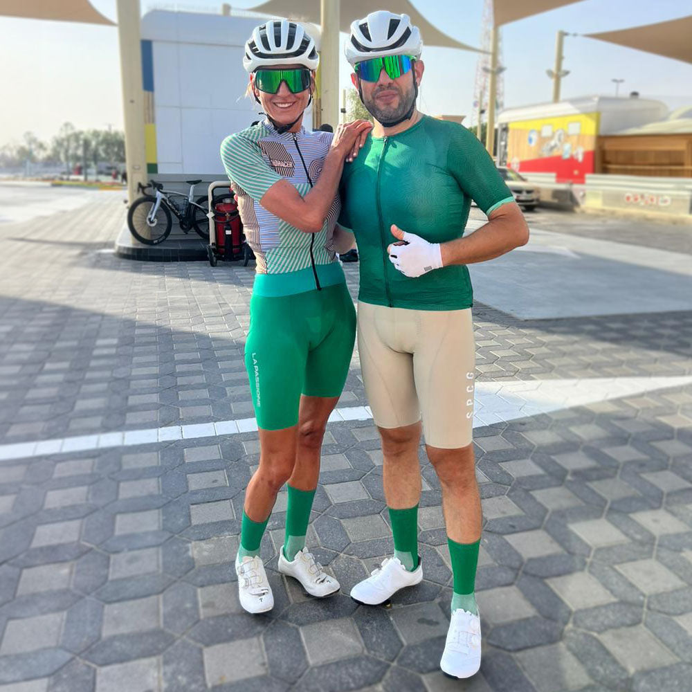 Two riders wearing green cycling socks from Veto which complement their outfits