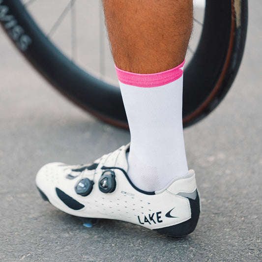 Crisp white cycling socks with a statement pink cuff