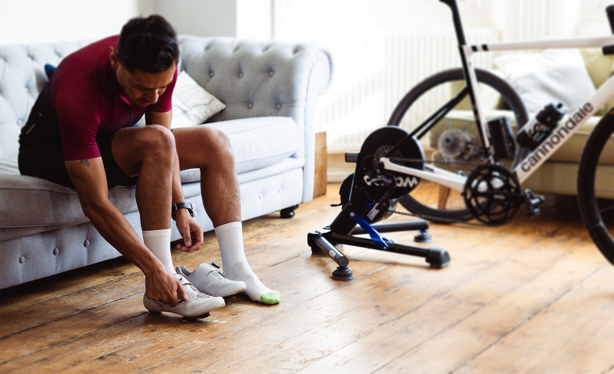Rider experiencing Veto socks whilst putting on cycling shoes